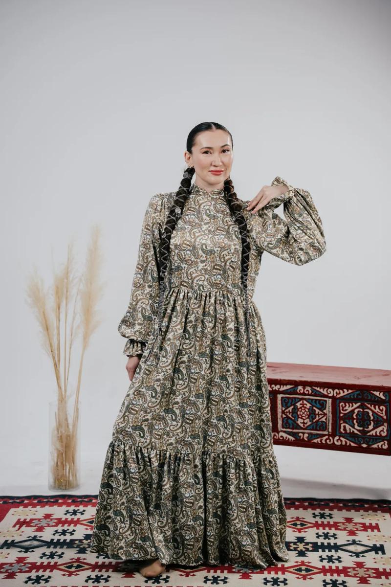 Banu Gaidar in a long patterned dress, full length