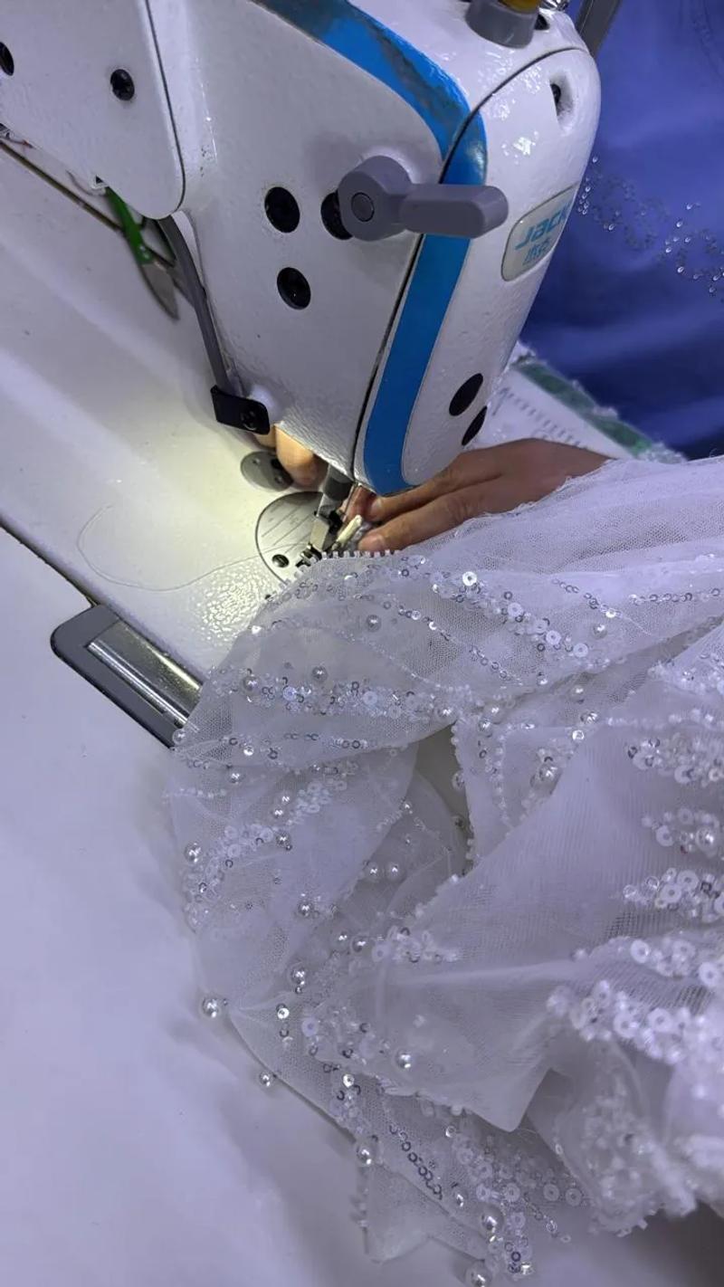 A beaded dress under the sewing machine