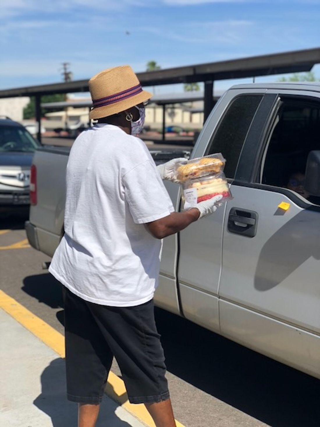 A Feeding Phoenix volunteer serving a family at a distribution