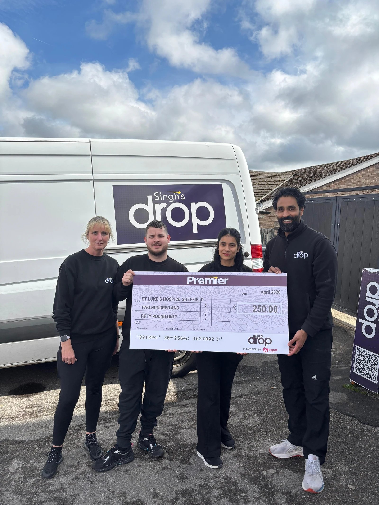 Four people beside a Singh's Drop van holding a presentation cheque for St Luke's Hospice Sheffield