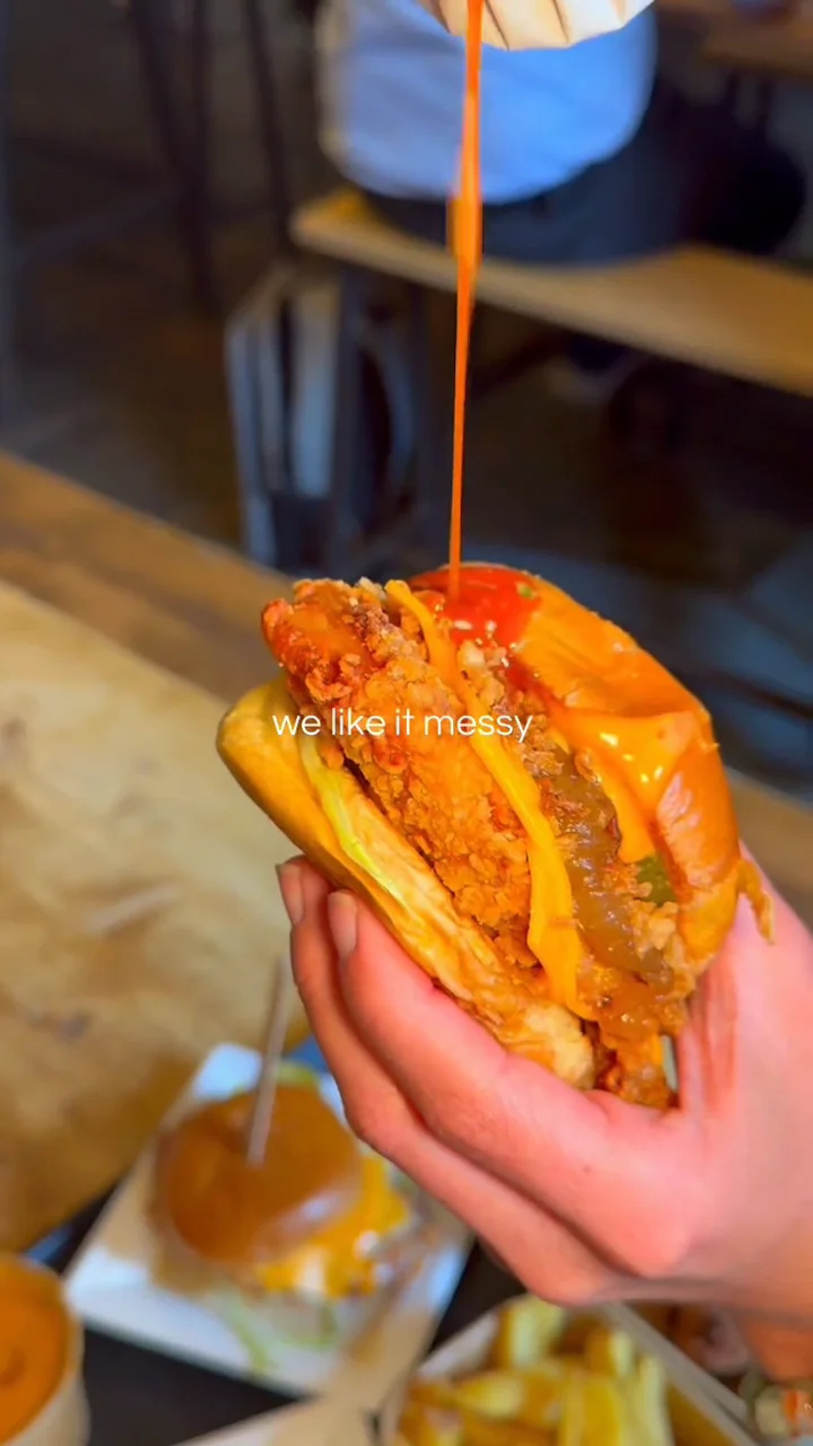 Sauce being drizzled over a Big Buns burger at Northern Market