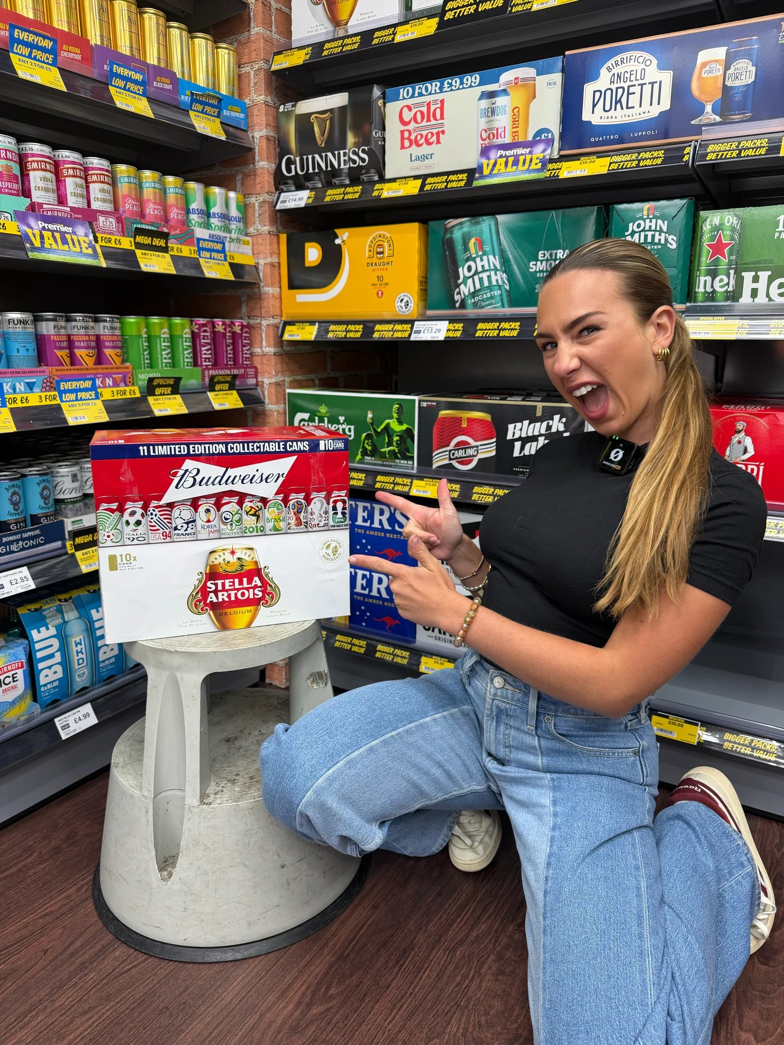A presenter reacting to a snack product in front of stocked Singh's shop shelves