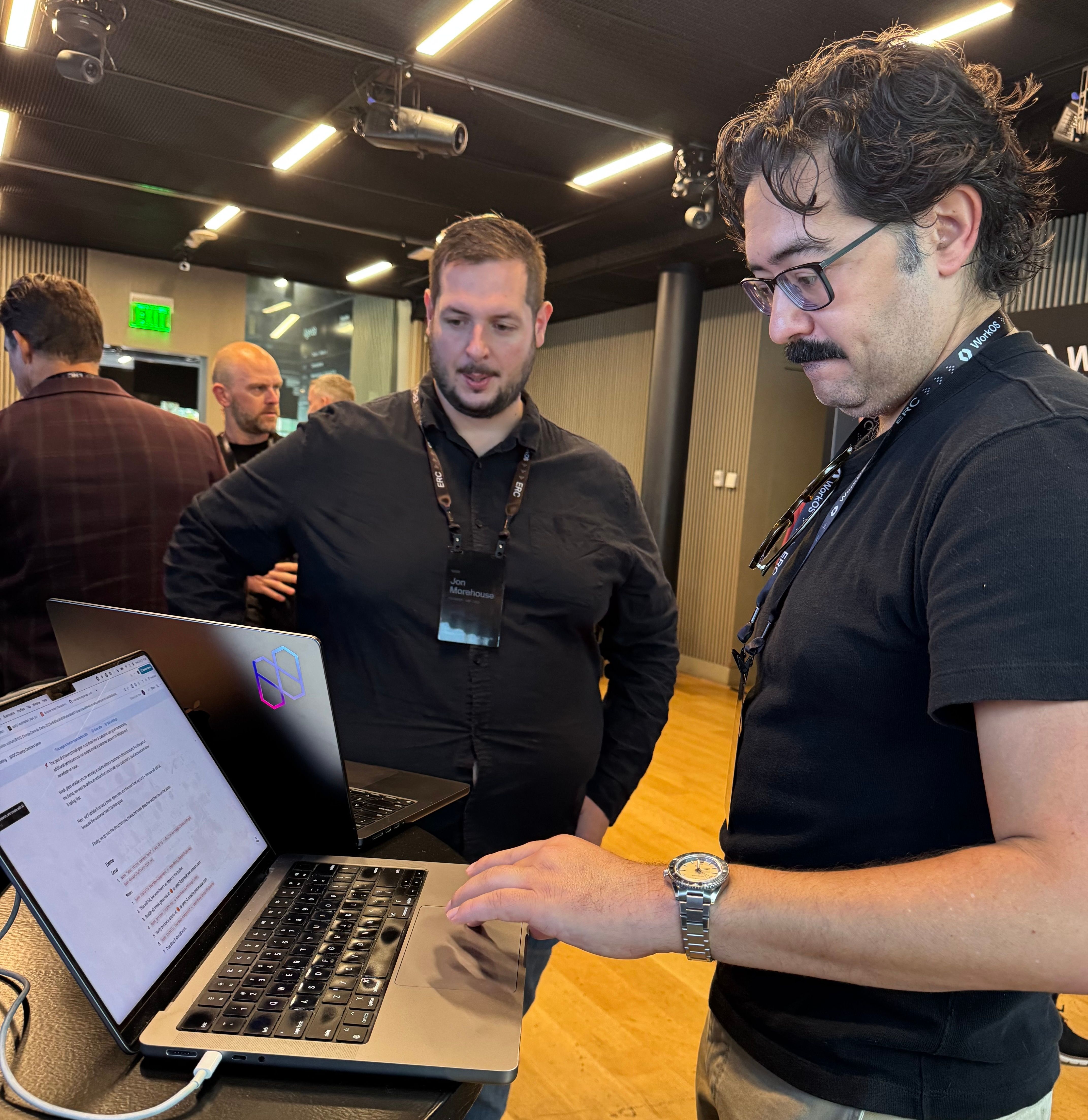 Two people at the nuon booth live demoing our product and talking through BYOC