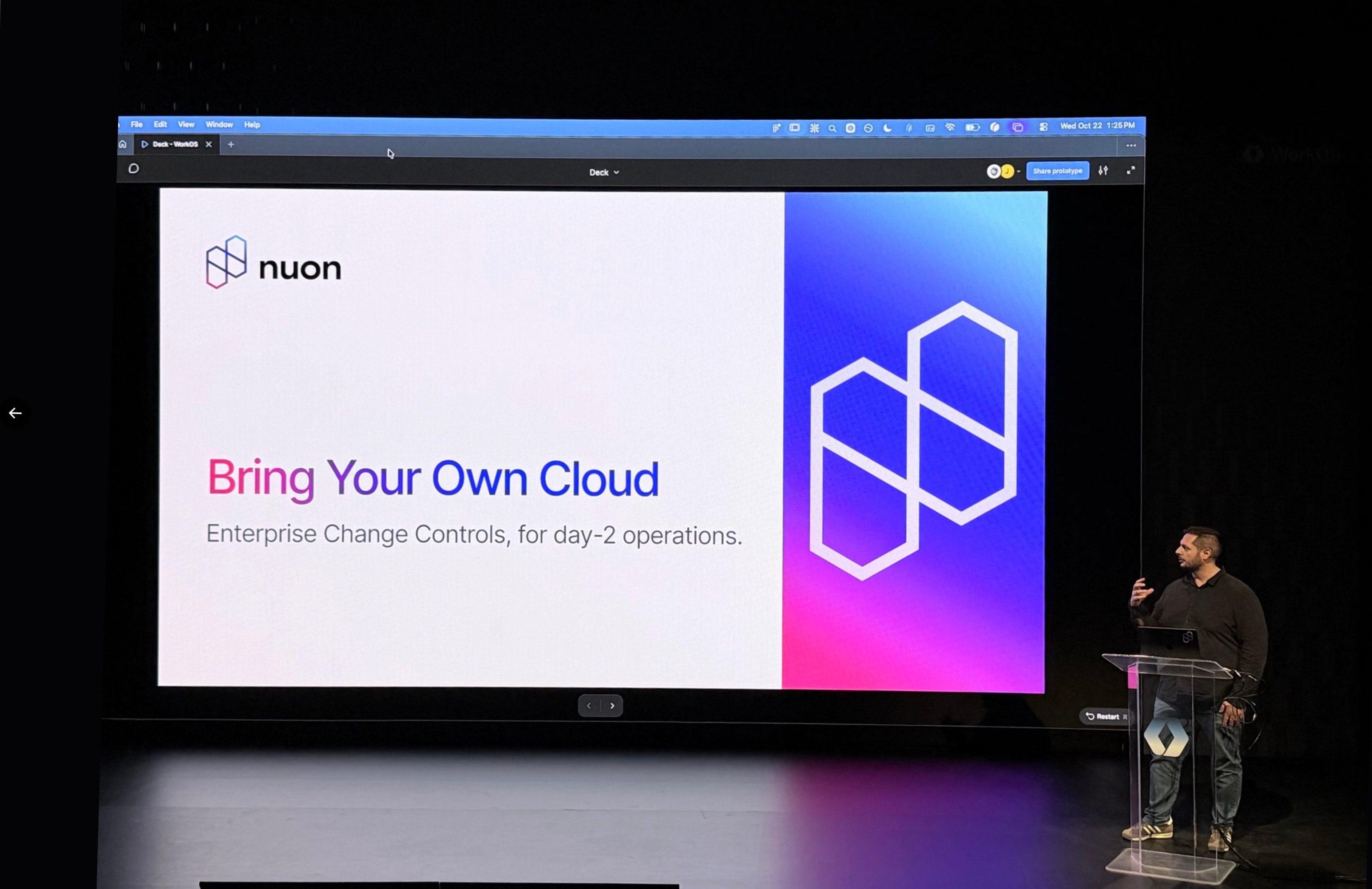 The founder and CEO of Nuon Jon Morehouse giving a on stage demo while the screen displays the title slide