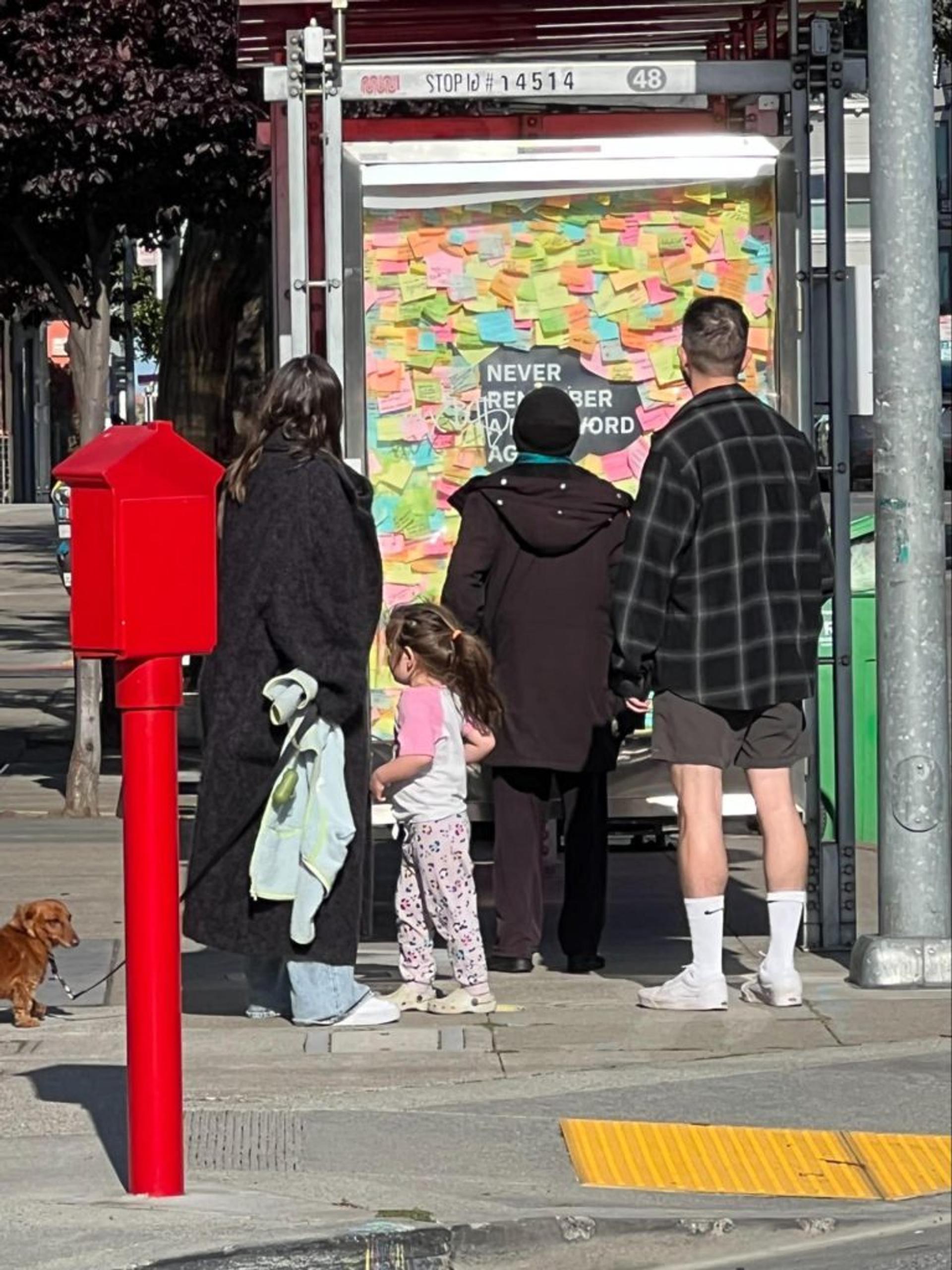 Pedestrians looking at ad