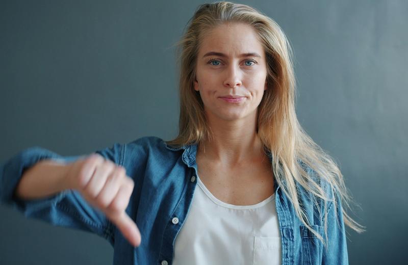 Woman giving a thumbs down gesture