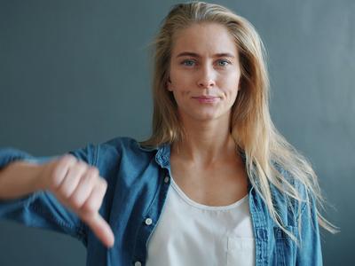 Woman giving a thumbs down gesture