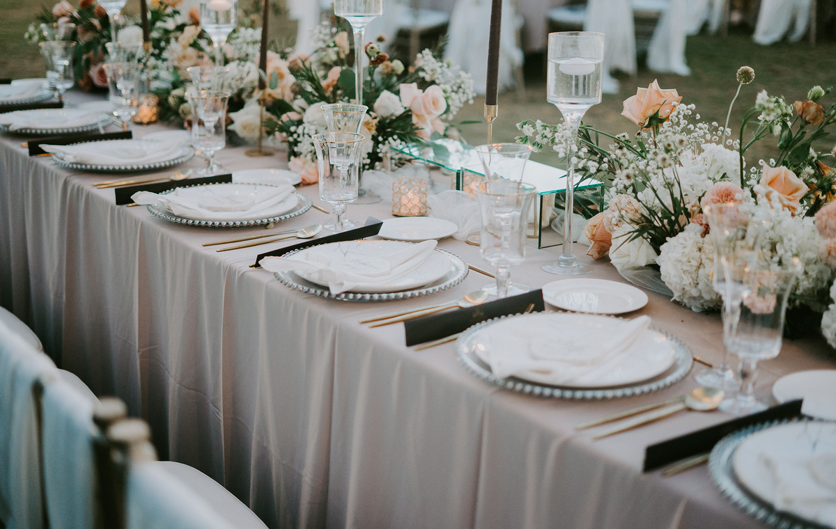 Beautifully decorated wedding reception table with floral arrangements and elegant tableware.