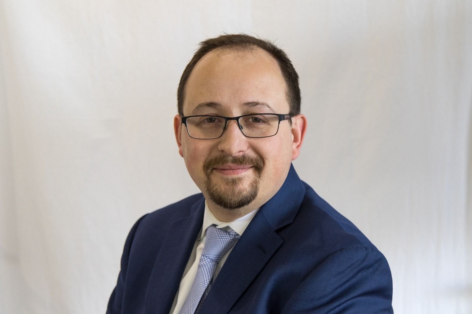 Dmitry Khenkin in a navy suit