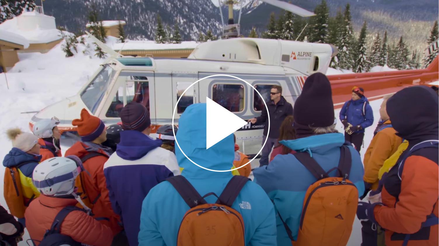 Guide providing helicopter safety briefing to guests