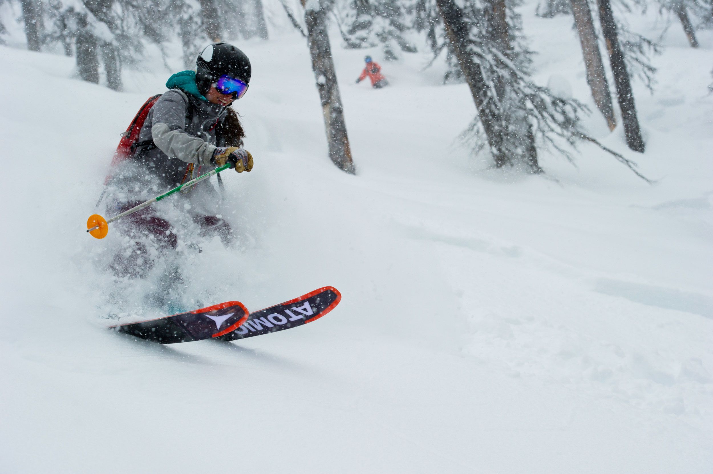 Woman skiing through trees