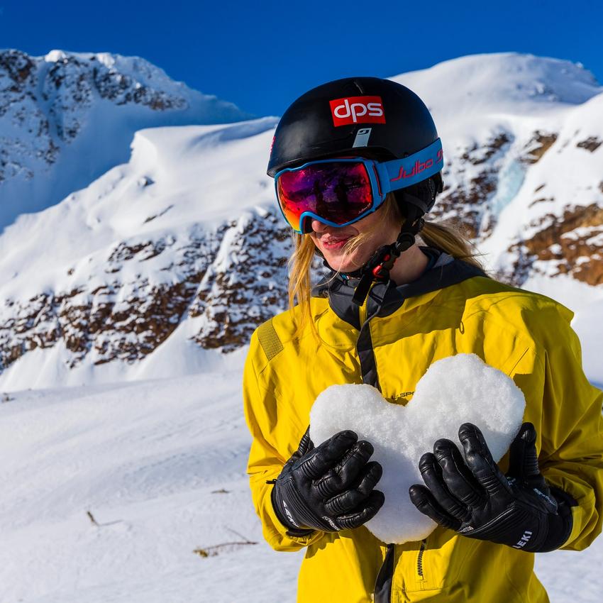 Woman holding a heart made of snow