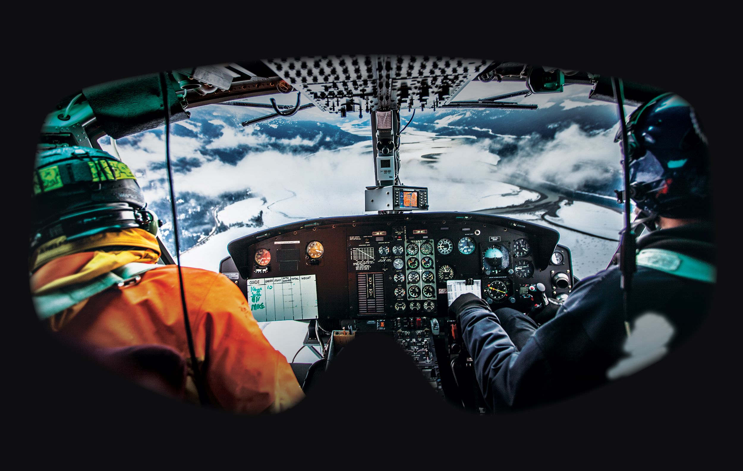 A ski guide and pilot flying a helicopter