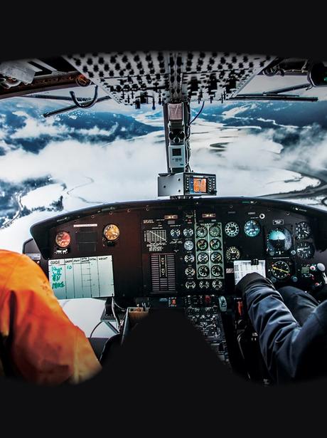 A ski guide and pilot flying a helicopter