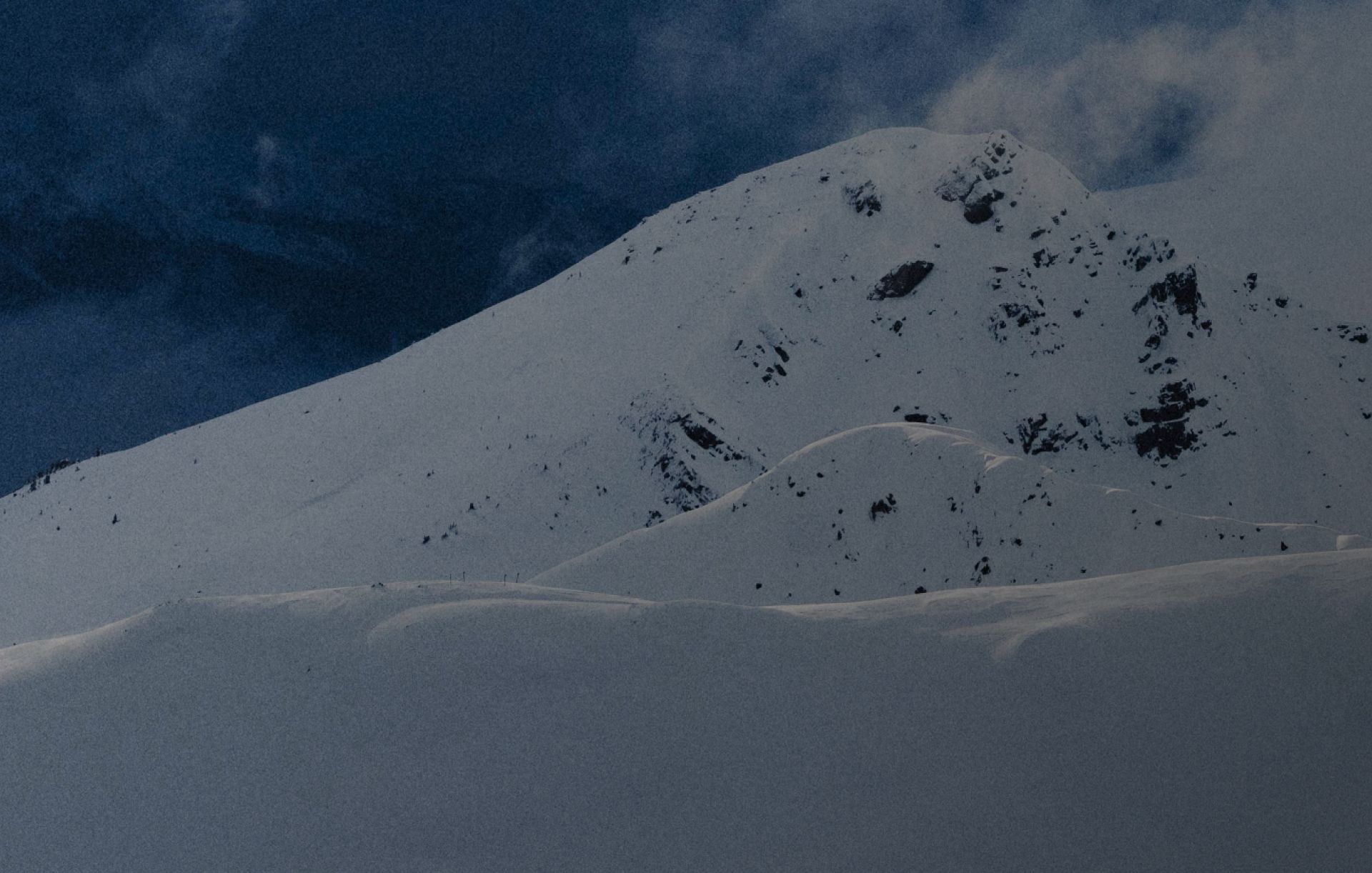 Snowy mountain under a blue sky