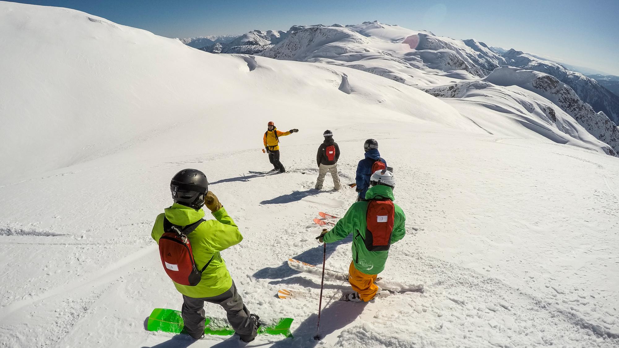 A ski guide instructing a group of skiers
