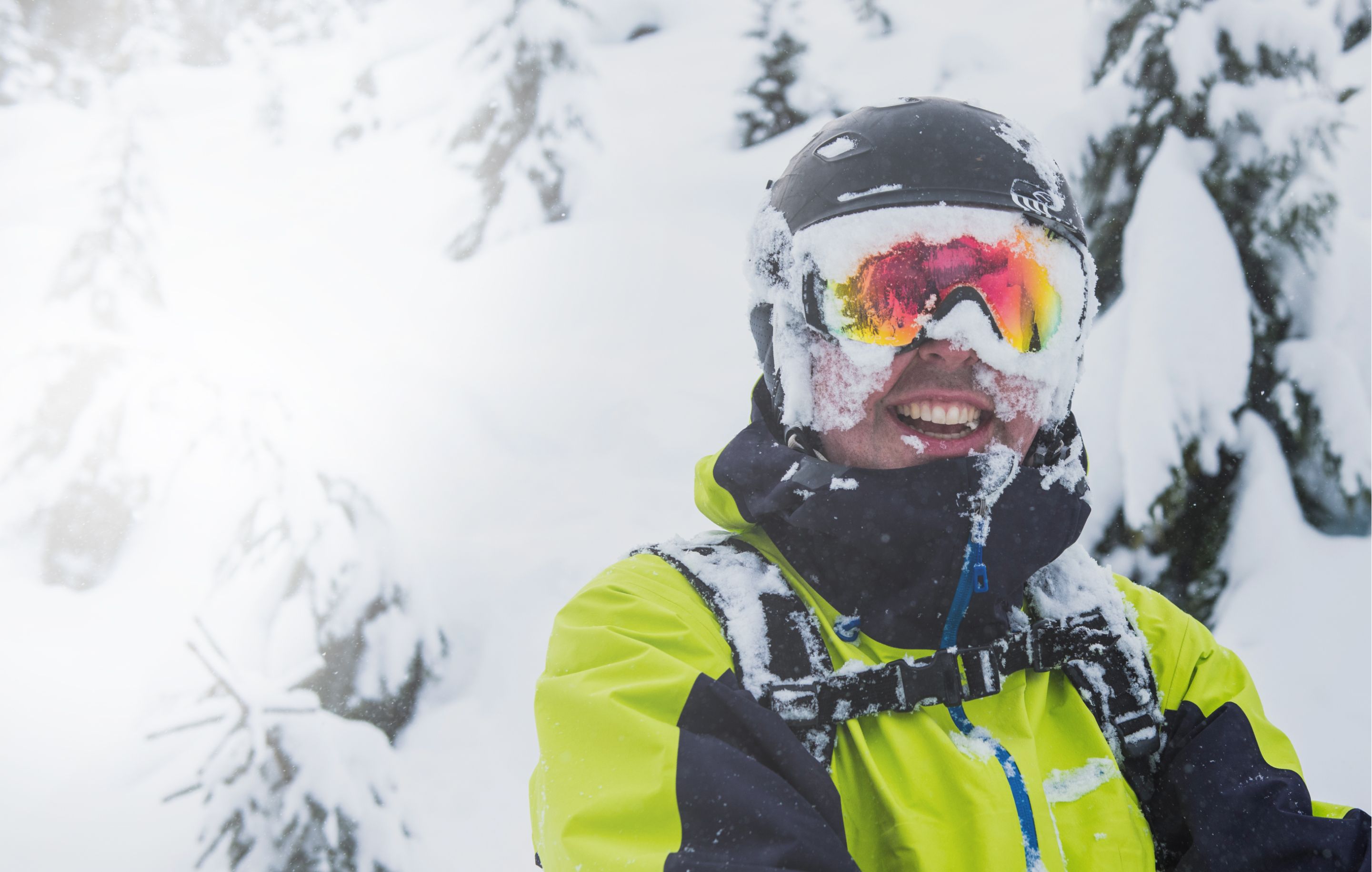 Skier smiling in a snowy forest