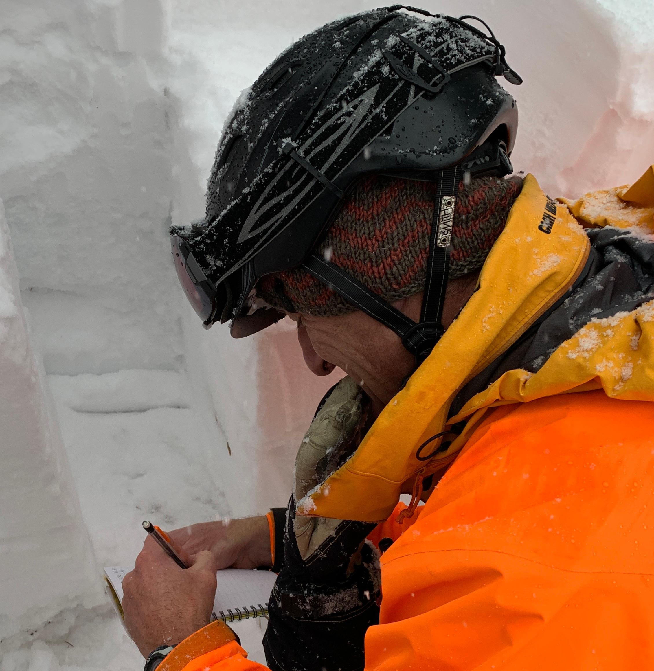 A ski guide taking snow samples