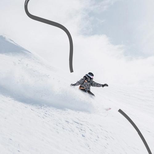 Snowy mountain scenery and a single snowboarder making a turn.
