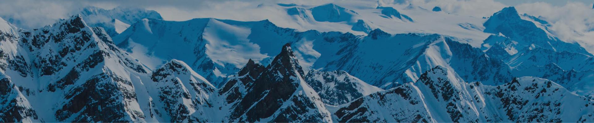 towering snow-covered peaks and glaciers in the canadian rockies showcasing cmh heli-skiings vast mountain terrain