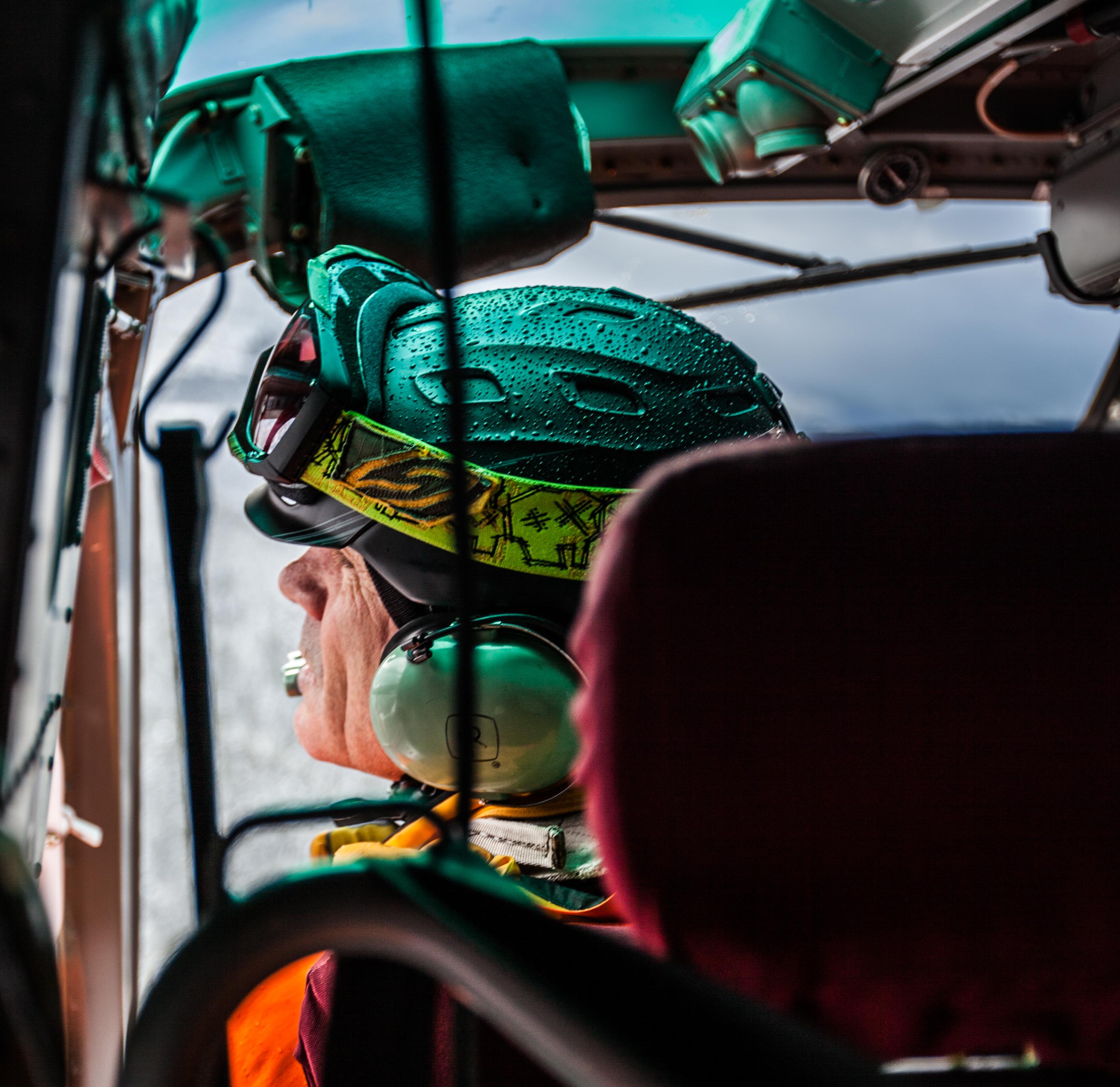 A mountain guide in a helicopter
