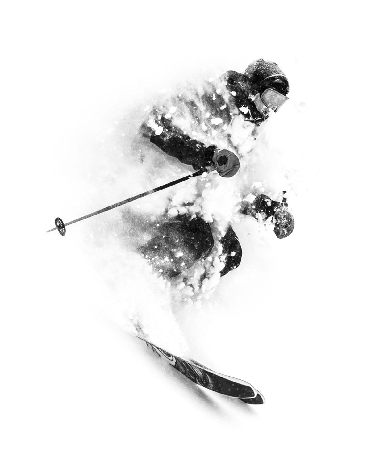 Black and white image of a skier in deep powder
