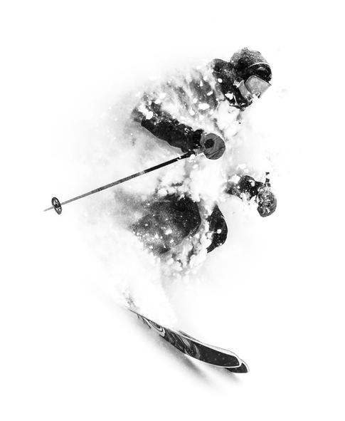 Black and white image of a skier in deep powder
