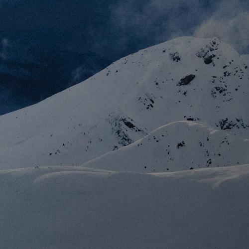 Snowy mountain under a blue sky