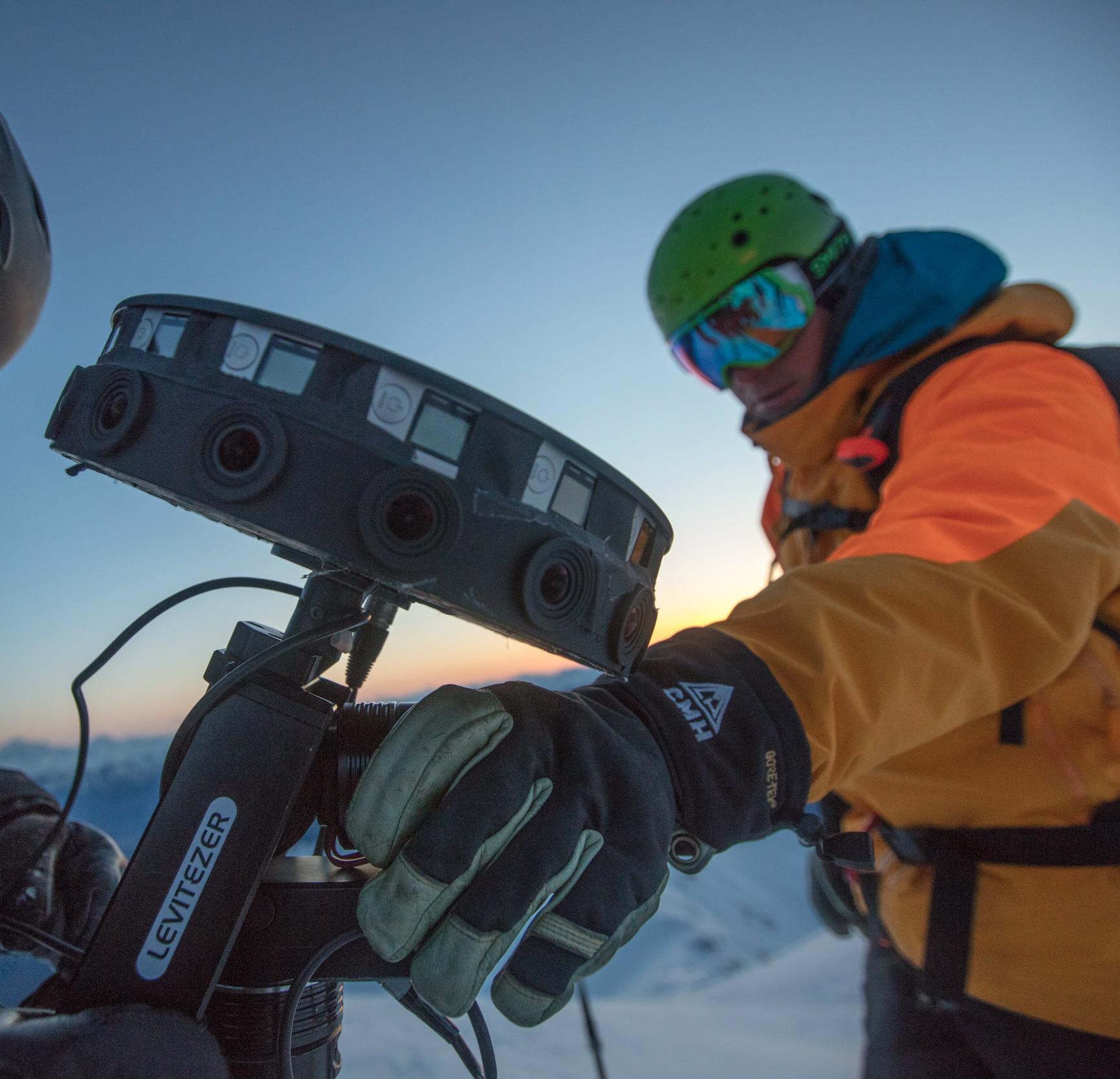 A ski guide operating a camera