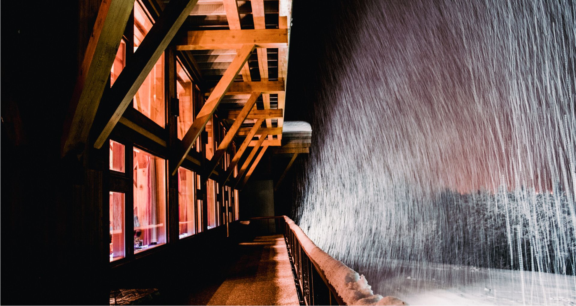 A night scene of a snowy winter lodge