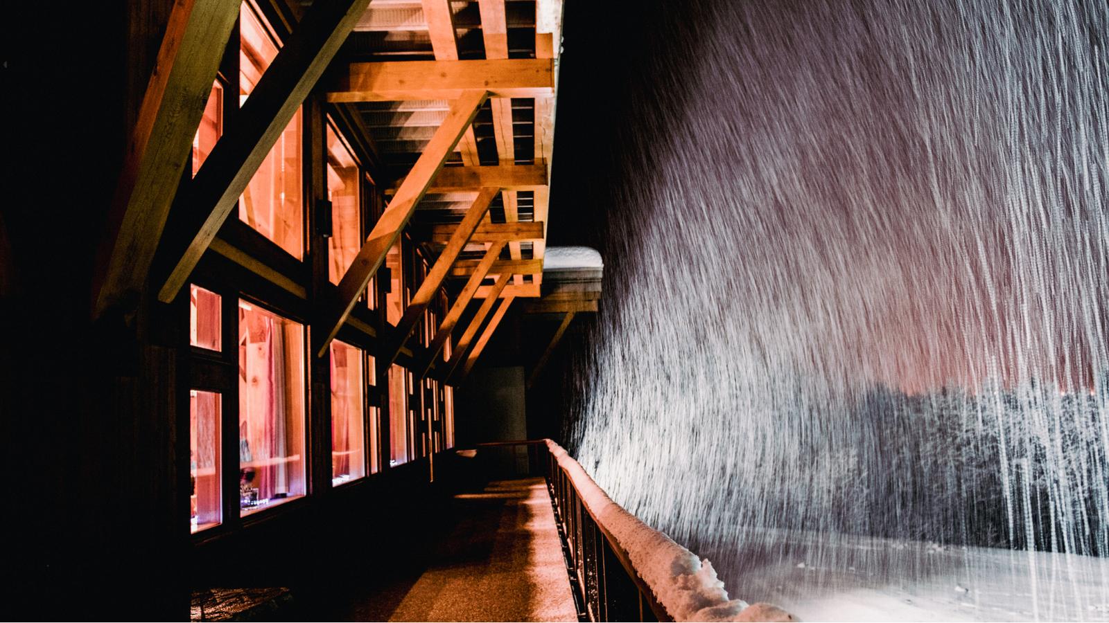 A night scene of a snowy winter lodge