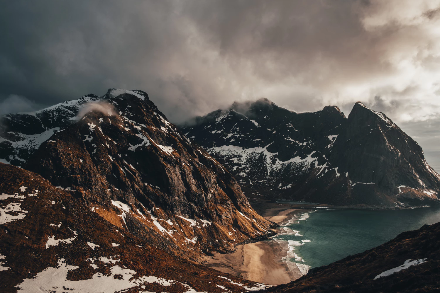 Mountains in cloudly weather with a beach.