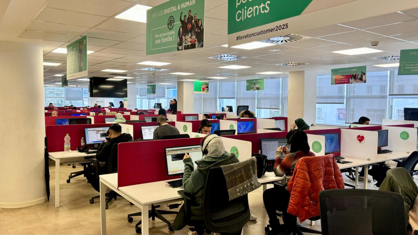 Advisers at their desks on an open-plan contact centre floor