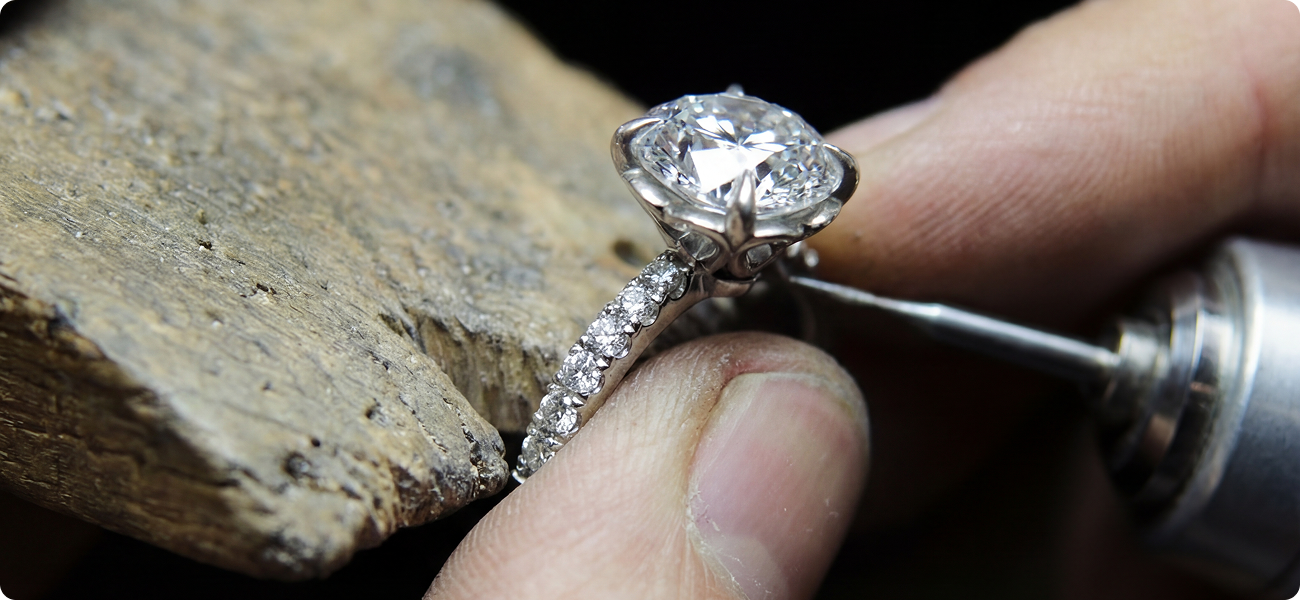 Artisan polissant une bague de fiançailles dans notre atelier au Québec.