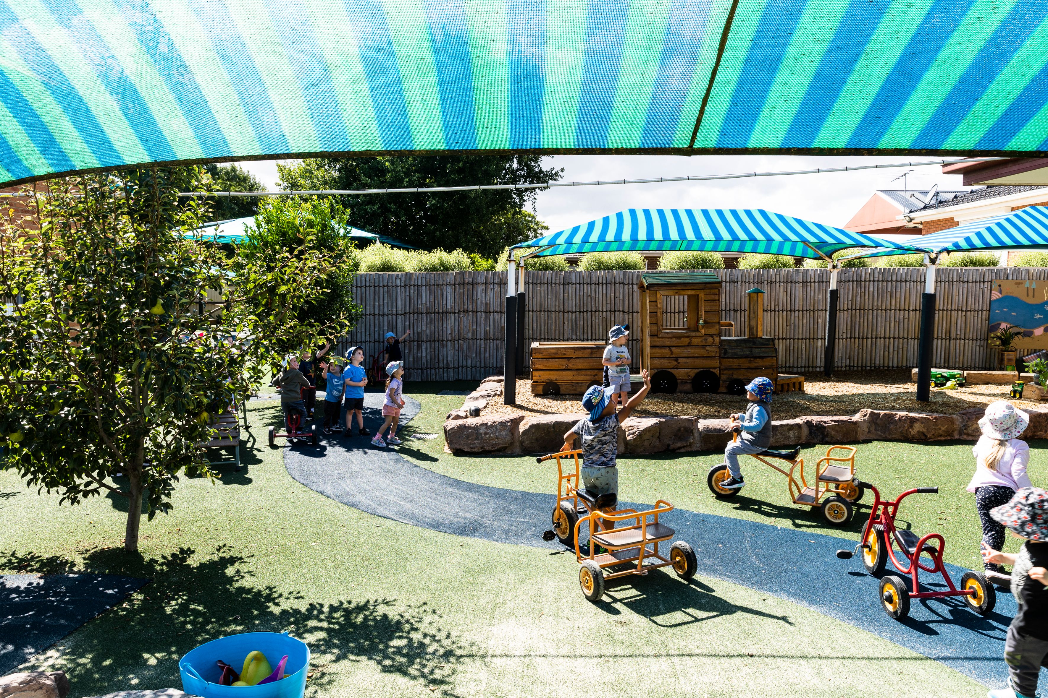 A sunny playground with children running around playing