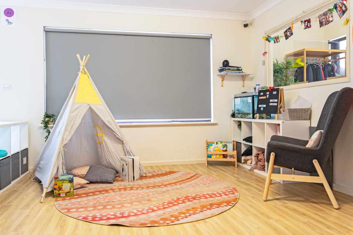 A room with an indoor tent and book shelf
