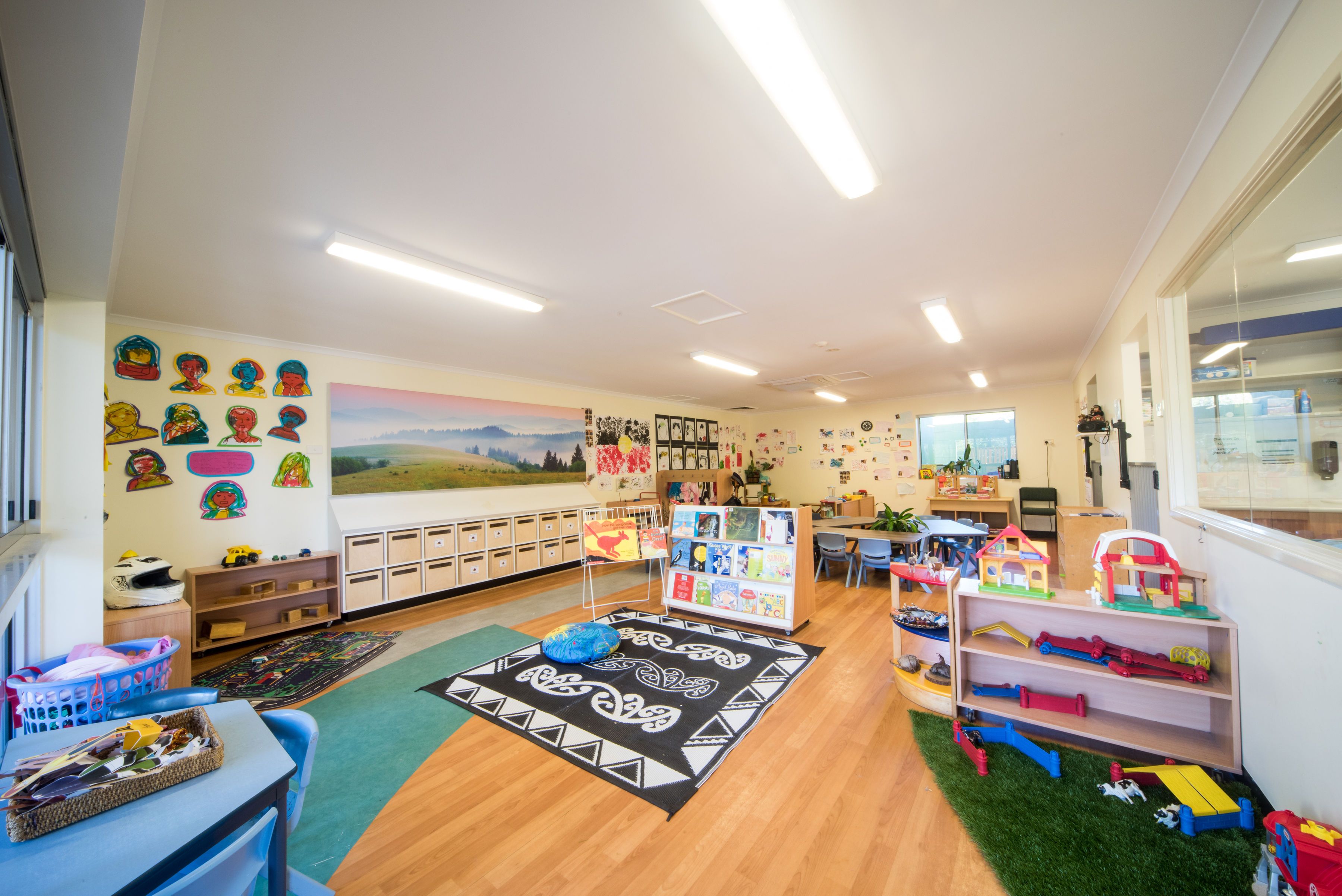 A bright kindergarten room filled with books and toys