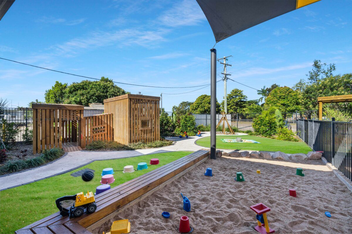 A large playground with equipment and a sandpit