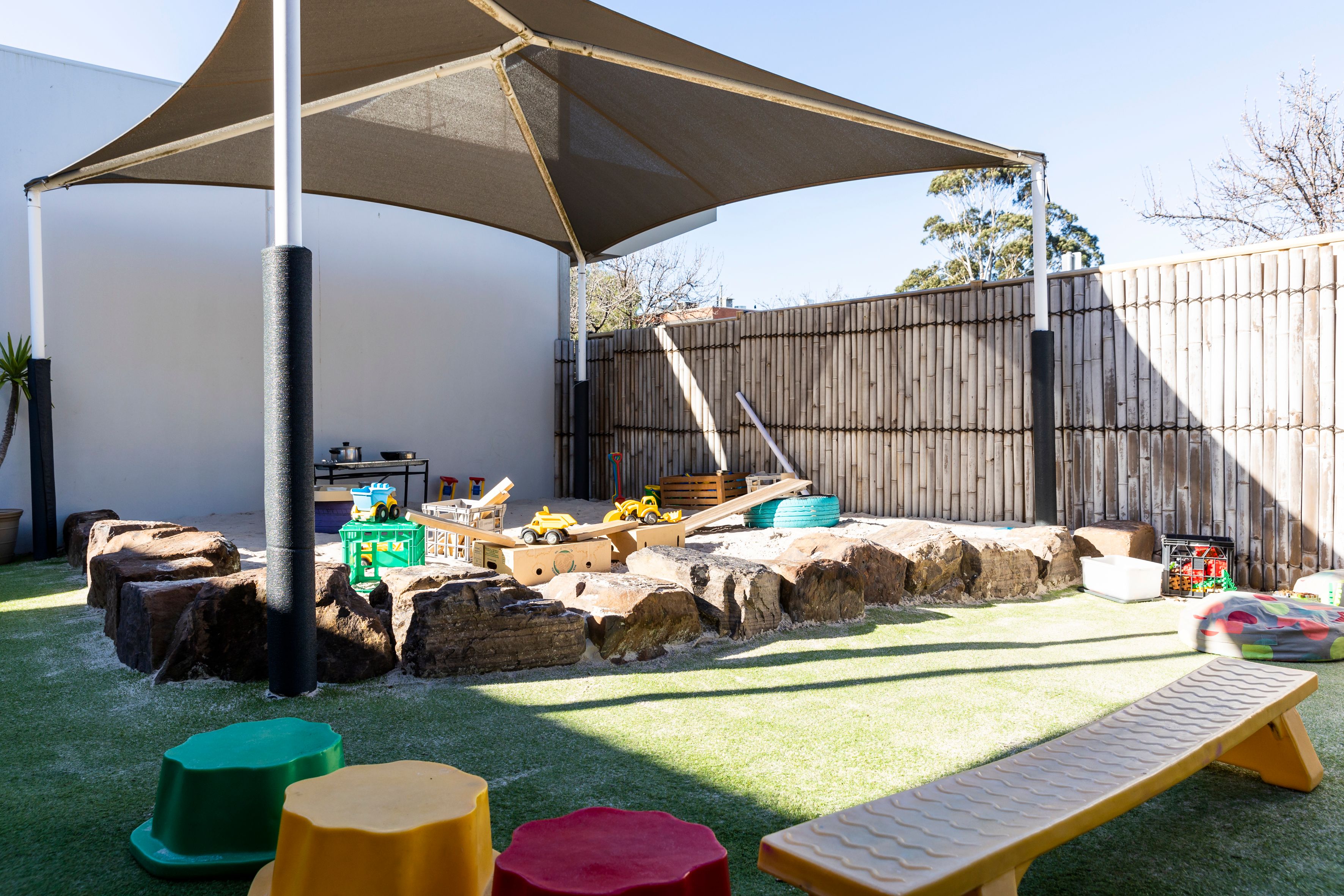 An outdoor shaded sandpit