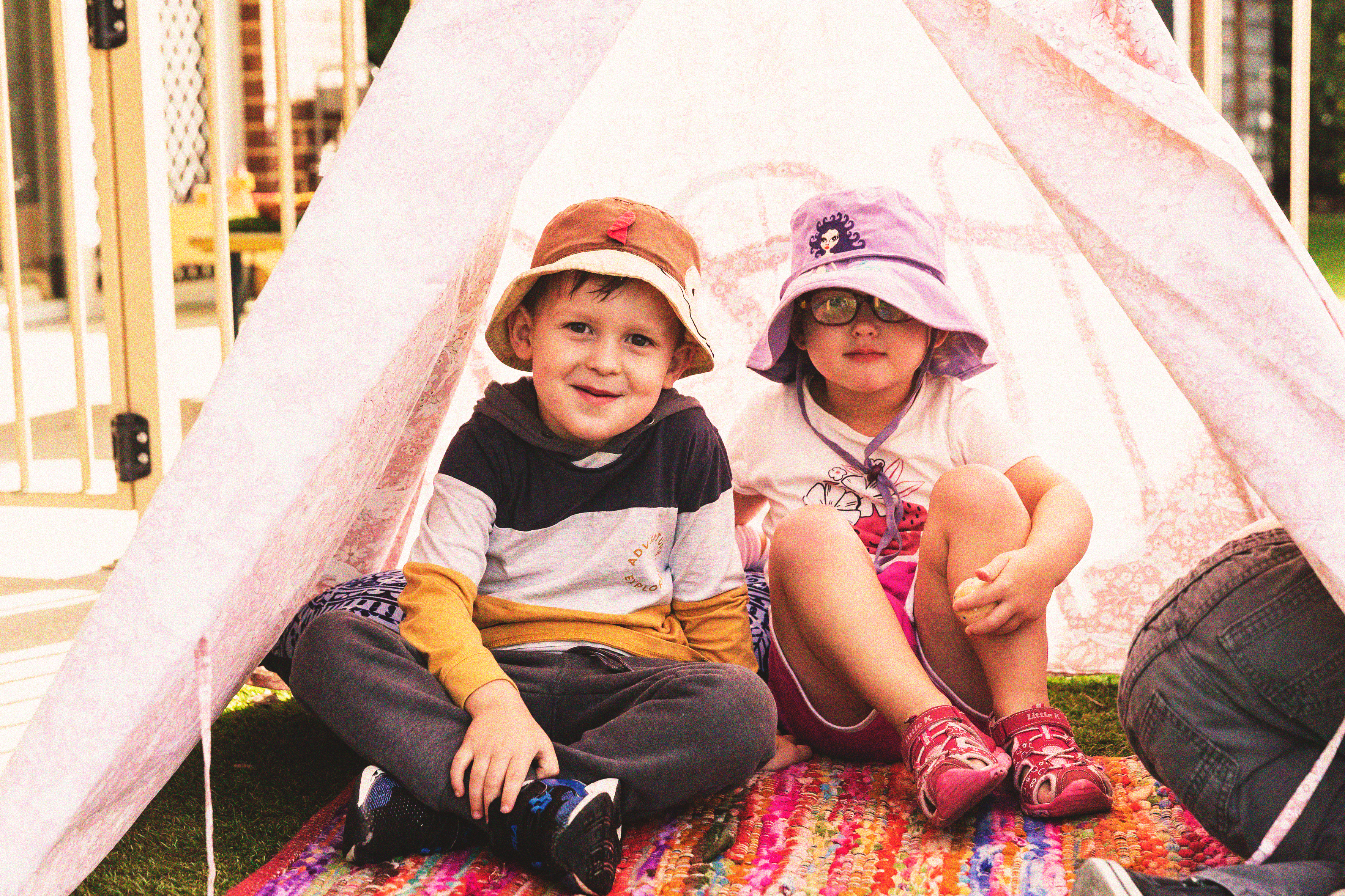 Two young children in a tent