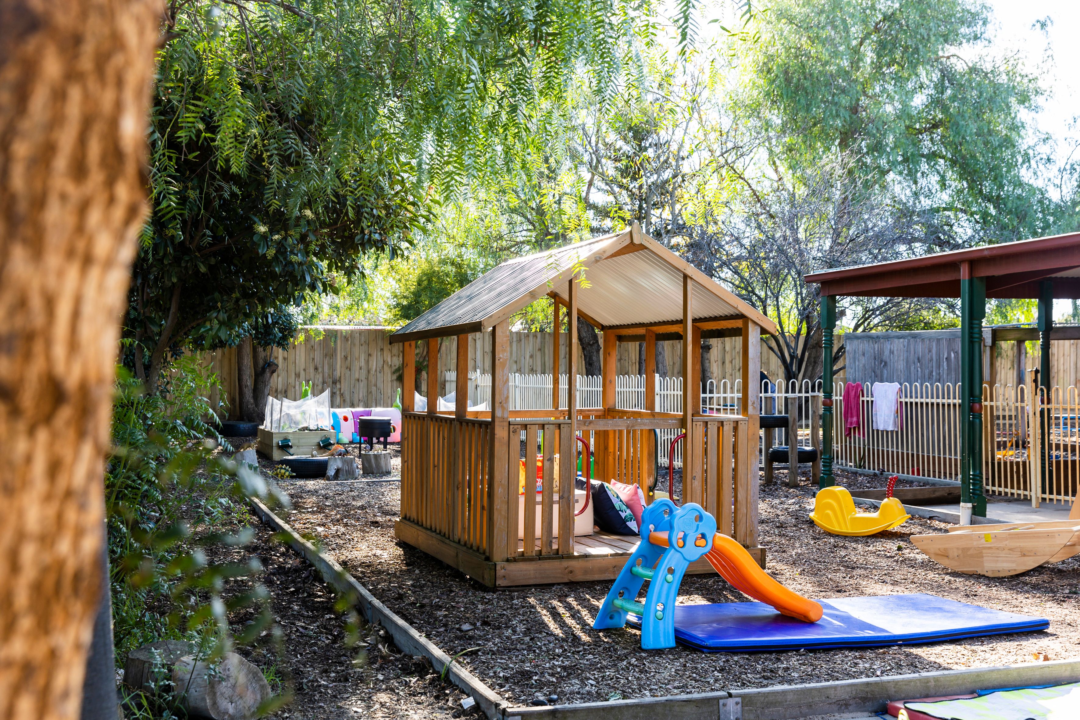 Tree-lined garden with play equipment 