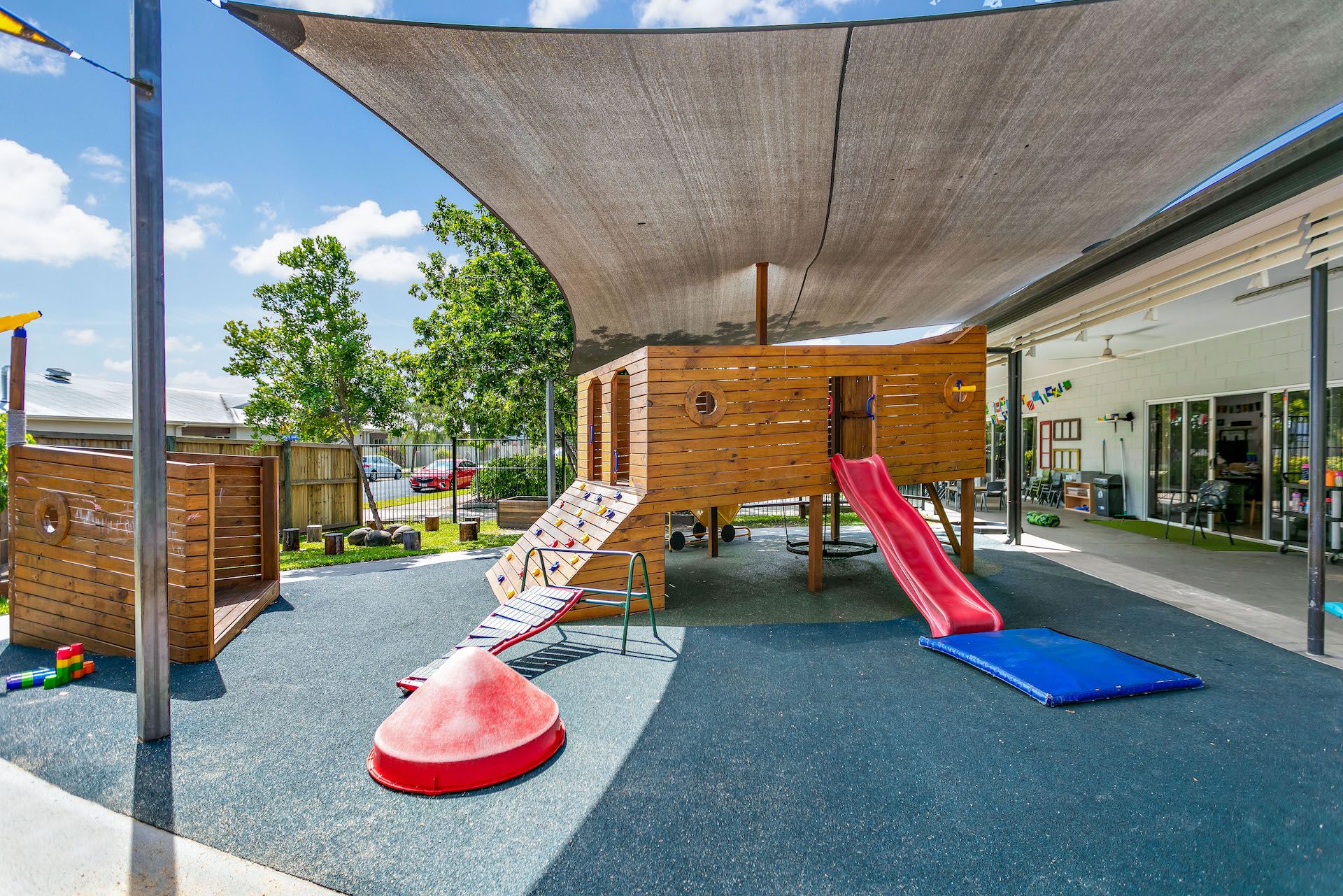 A shady playground with lots of play equipment