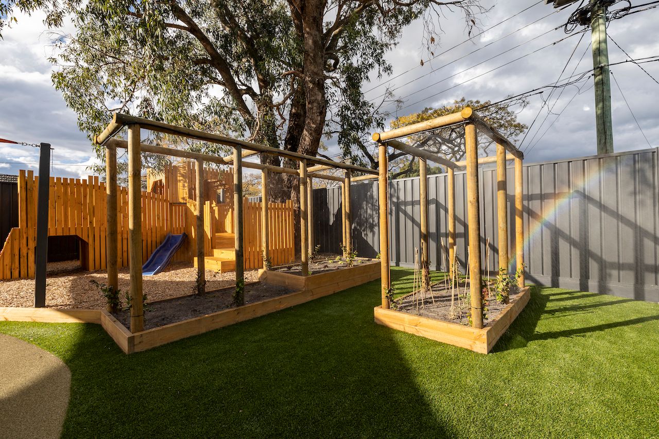 A garden with climbing frames and vegetable patches
