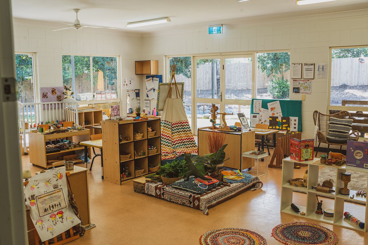 A bight classroom filled with books and toys