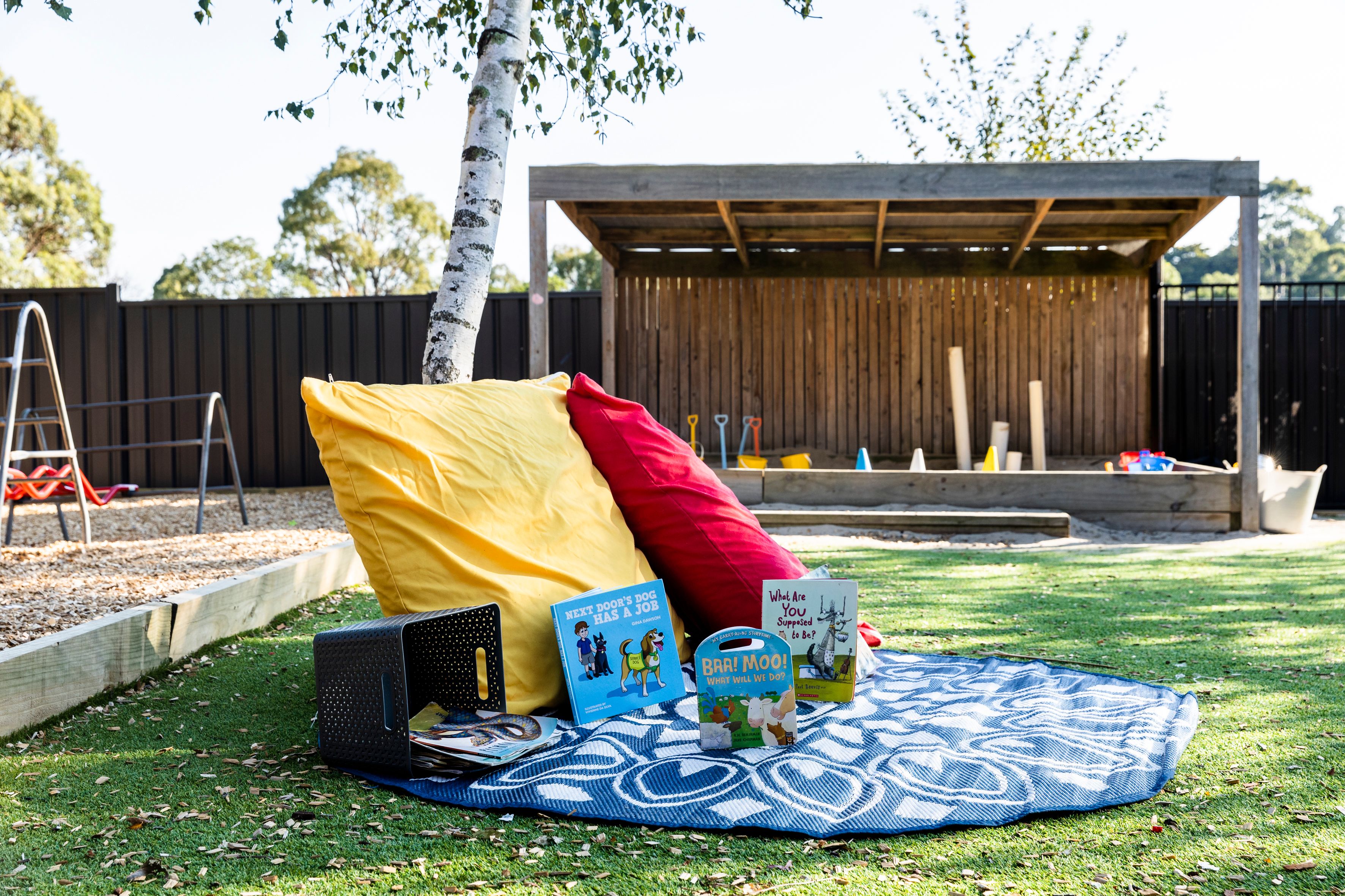 Some cushions and a blanket set up for reading