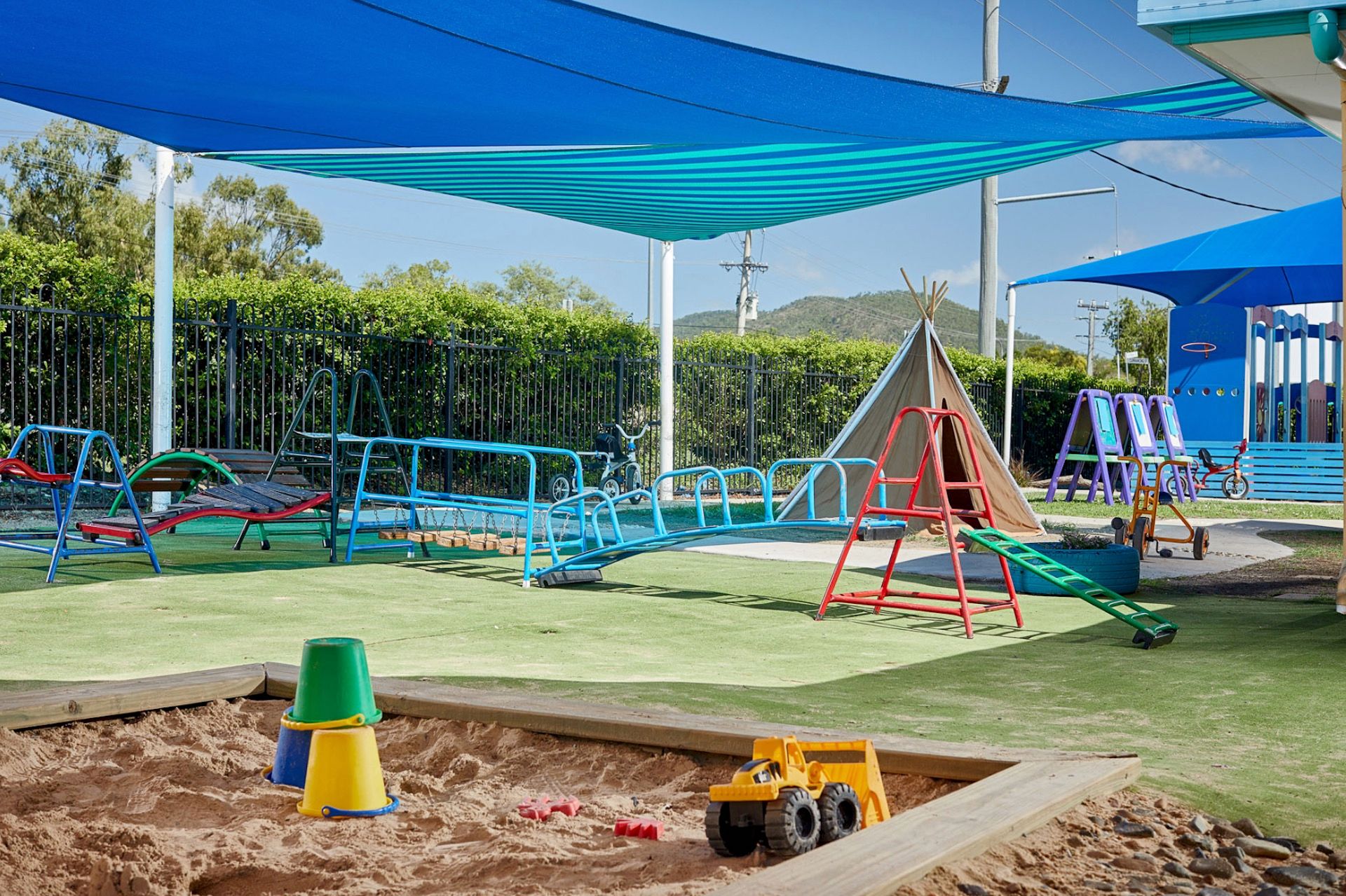 A large open playground with sandpits and climbing frames
