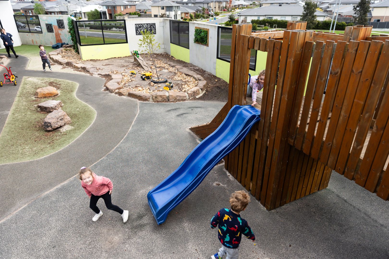 An outdoor playground with sandpits and plants