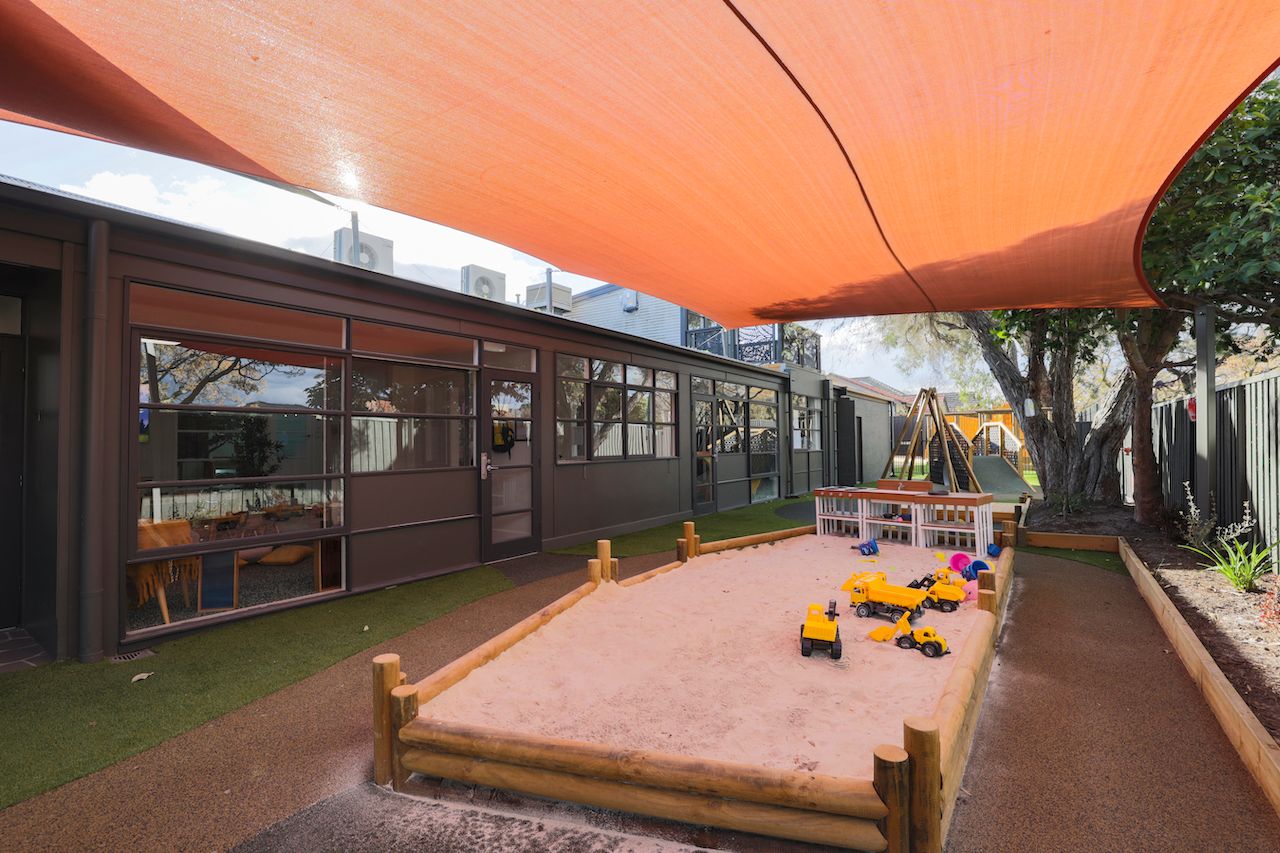 A large shaded outdoor sandpit