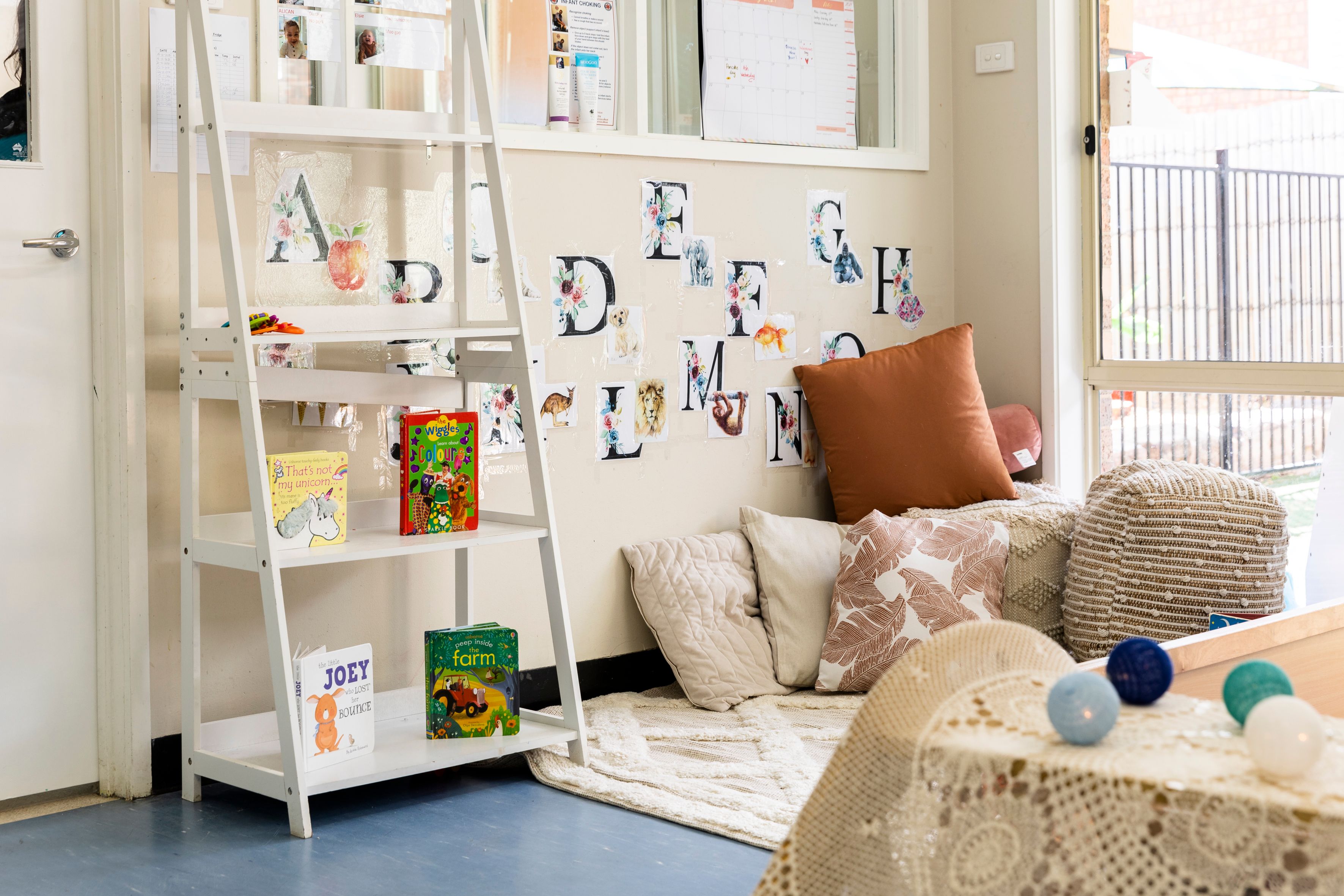 A cosy corner with pillows and book shelves