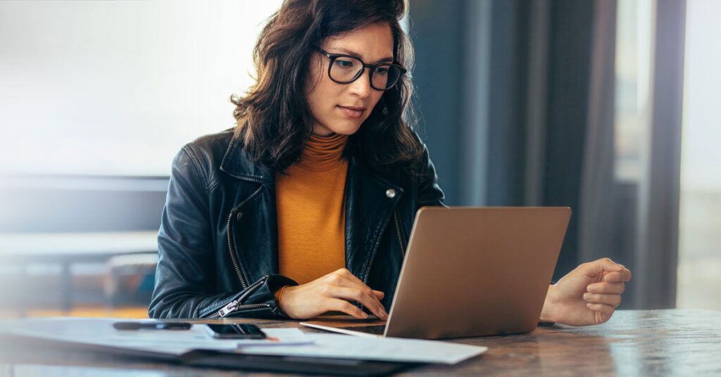 woman at desk engaged with work she is doing